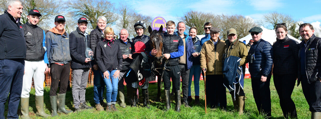 Ballynoe point to point mare winner photographed alongside attendees